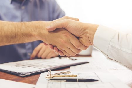 Couple and a realtor Couple visiting a realtor. Men are shaking hands